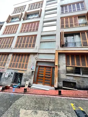 a tall building with wooden doors on a city street at Central Apartment Close to Galataport in Istanbul