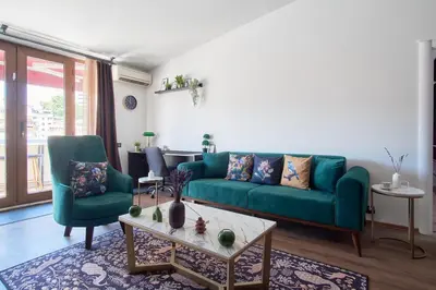 a living room with a green couch and two chairs at Cozy Penthouse with the Balcony in Istanbul