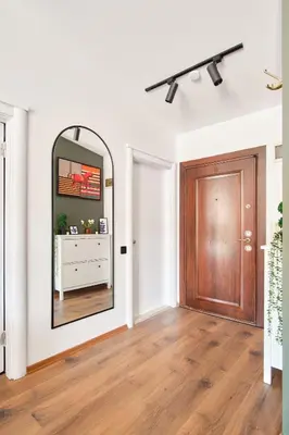 a hallway with a mirror and a wooden door at Cozy Penthouse with the Balcony in Istanbul