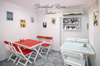 a dining room with a red and blue table and chairs at Istanberry - Scarlet Apartments in Istanbul