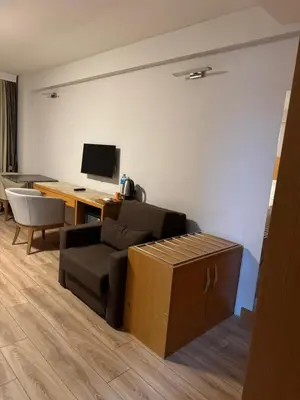 a living room with a couch and a desk with a computer at PALMIYE hotel SUITES in Istanbul