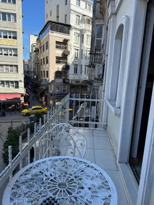 a balcony with a table and a view of a city at PALMIYE hotel SUITES in Istanbul