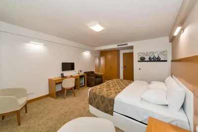 a hotel room with a bed and a desk at PALMIYE hotel SUITES in Istanbul