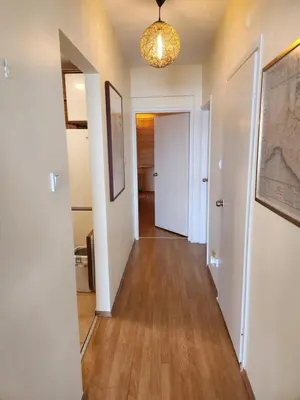 a hallway with white walls and wood floors at Stunning 1BR w Sea View close to Galataport ! in Istanbul