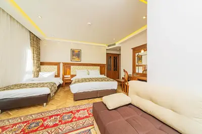 a hotel room with two beds and a couch at Hotel Spectra Sultanahmet in Istanbul