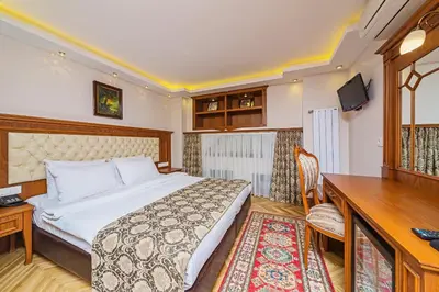 a bedroom with a bed and a desk and a computer at Hotel Spectra Sultanahmet in Istanbul