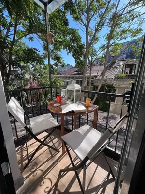 a patio with a table and chairs on a balcony at Rum Otto Enjoy Relax 30 sec to Taksim Bathtub in Istanbul