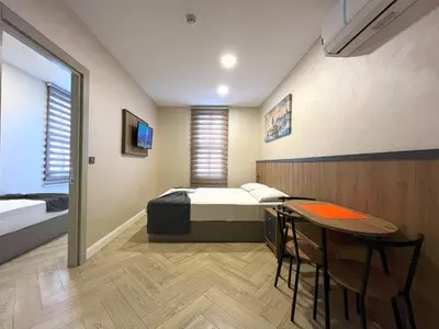 a bedroom with a bed and a table in it at Valens Butik in Istanbul