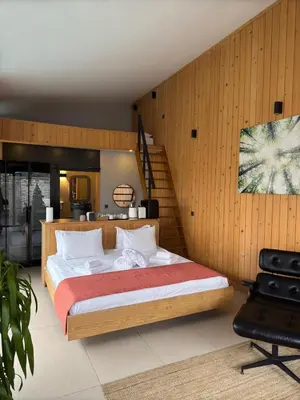 a bedroom with a large bed and a staircase at Prime Suites in Kadıköy