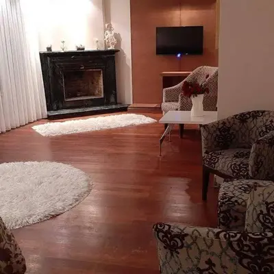 a living room with a fireplace and two rugs at Synosse Park Hotel in Istanbul