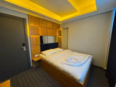 a small bedroom with a bed with a large white blanket at Premium Palace in Istanbul