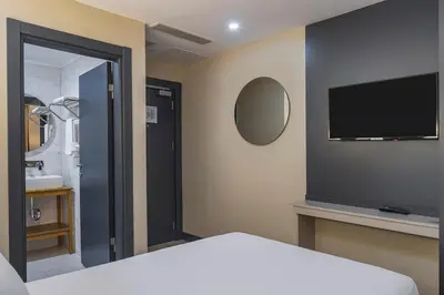 a bedroom with a bed and a tv on the wall at Garner Hotel Istanbul - Airport Arnavutkoy by IHG in Istanbul