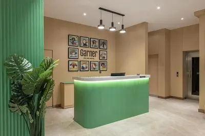 a lobby with a green counter and a plant at Garner Hotel Istanbul - Airport Arnavutkoy by IHG in Istanbul