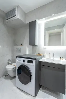 a bathroom with a washing machine and a sink at Chido Residence in Istanbul