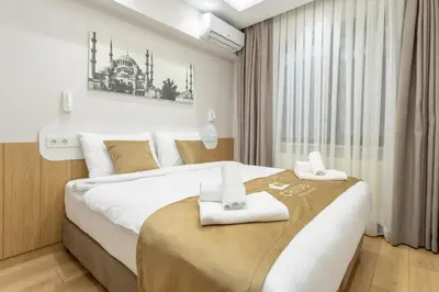 a bedroom with a large bed with towels on it at Chido Residence in Istanbul