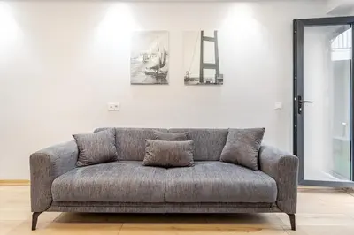 a gray couch in a living room with a wall at Chido Residence in Istanbul