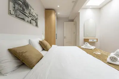 a bedroom with a large white bed and a mirror at Chido Residence in Istanbul