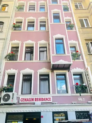 a pink building with flowers in the windows at TAKSİM CMLM Suit in Istanbul