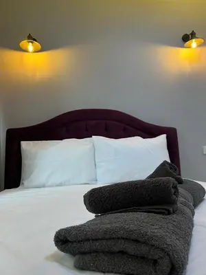 a bed with a pile of towels on it at TAKSİM CMLM Suit in Istanbul