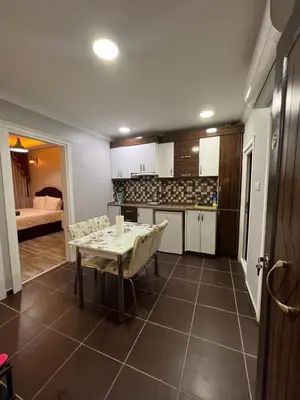 a kitchen and living room with a table and a couch at TAKSİM CMLM Suit in Istanbul