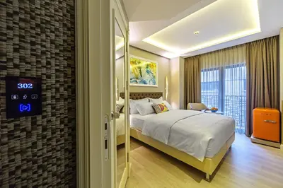 a hotel room with a bed and a clock on the wall at Barbera Hotel in Istanbul