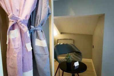 a room with a curtain and a chair at Barbera Hotel in Istanbul