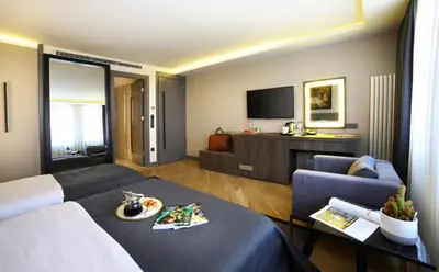 a living room with a couch and a tv at The Capital Suites in Istanbul
