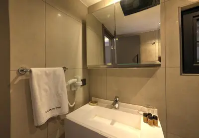 a bathroom with a sink and a mirror at The Capital Suites in Istanbul