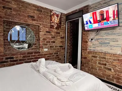 a bed in a room with a brick wall at Sultanahmet Apart Hotel in Istanbul