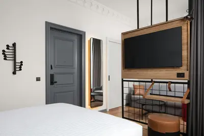 a bedroom with a bed and a tv on a wall at Moxy Istanbul Taksim in Istanbul