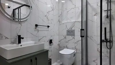 a bathroom with a sink and a toilet and a mirror at farazarooms in Serdivan