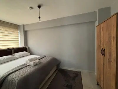 a bedroom with a bed with two towels on it at Zeus Suit Görükle in Nilüfer