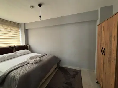 a bedroom with a bed with a towel on it at Zeus Suit Görükle in Nilüfer