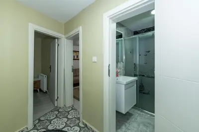 a bathroom with a white toilet and a sink at rest at home in Istanbul