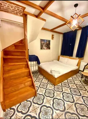 a bedroom with a bed and stairs in a room at Authentic Turkish Home Standard Room in Istanbul