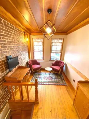 a room with chairs and a table and a brick wall at Authentic Turkish Home Standard Room in Istanbul