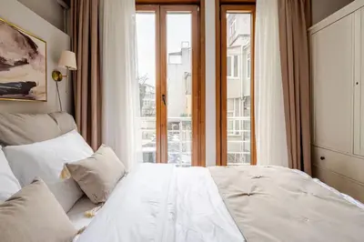 a white bed in a room with a window at Raya Cihangir Suites in Istanbul