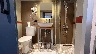 a bathroom with a toilet and a sink and a shower at Loft Black Sapanca in Sapanca