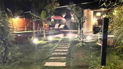 a backyard at night with a hammock in the grass at Loft Black Sapanca in Sapanca