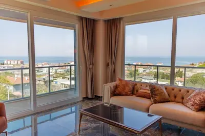 a living room with a couch and large windows at Comfort 4 bedroom villa yalova see view in Termal