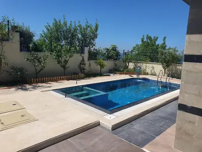 a swimming pool in a yard with at Comfort 4 bedroom villa yalova see view in Termal