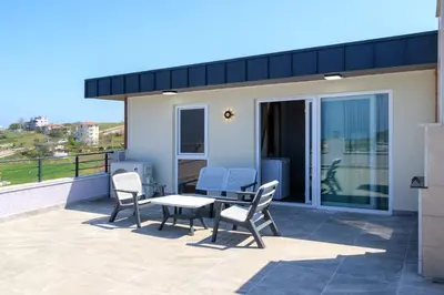 a patio with chairs and a table on a balcony at Comfort 4 bedroom villa yalova see view in Termal