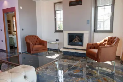 a living room with two chairs and a fireplace at Comfort 4 bedroom villa yalova see view in Termal