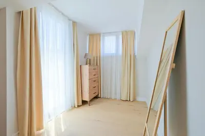 a mirror in a room with a dresser and a window at Mayer Skycon Residence in Beşiktaş 2 in Istanbul