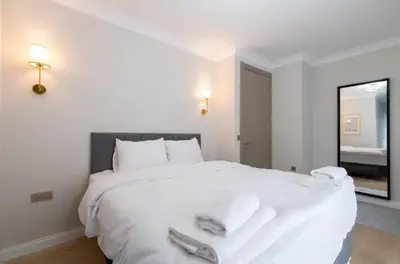 a bedroom with a large white bed with a mirror at Mayer Skycon Residence in Beşiktaş 2 in Istanbul