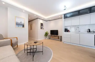 a living room with a couch and a table and a kitchen at Mayer Skycon Residence in Beşiktaş 2 in Istanbul