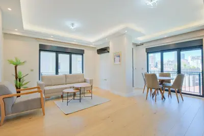 a living room with a couch and a table and chairs at Mayer Skycon Residence in Beşiktaş 2 in Istanbul