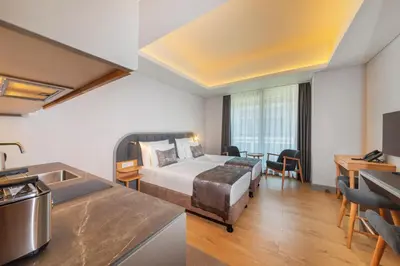 a hotel room with a bed and a kitchen at Meroddi Beyoğlu Residence in Istanbul