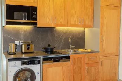 a kitchen with a washing machine and a sink at Meroddi Beyoğlu Residence in Istanbul
