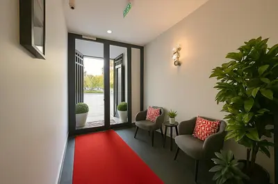a hallway with two chairs and a red carpet at Center Port Hotel Karaköy in Istanbul